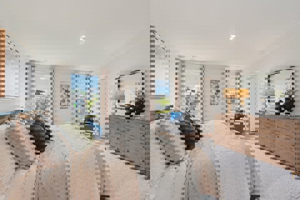 A large bedroom with a bed and a dresser.