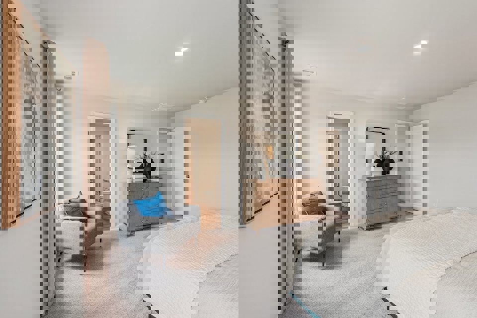 A bedroom with a bed and a chair.