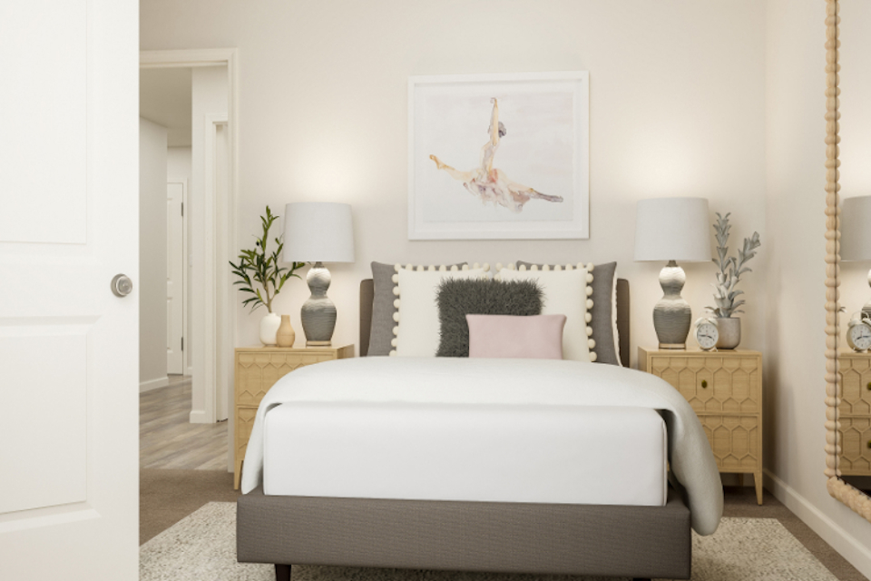 A bedroom with a bed and lamps.