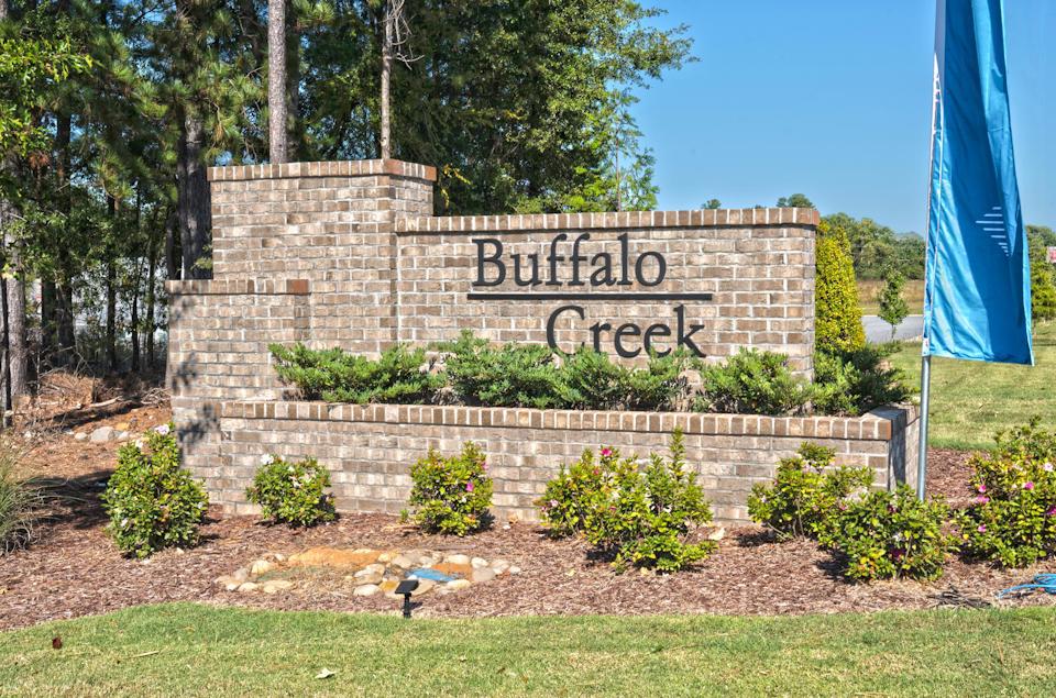 A sign on a brick wall.