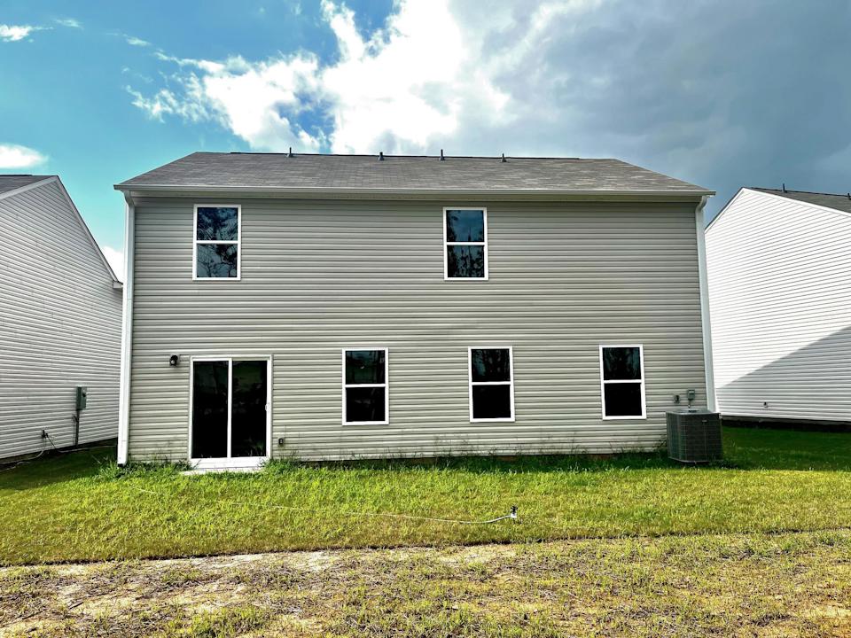 A grey house with windows.