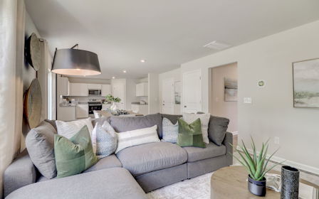 A living room with a couch and a table.
