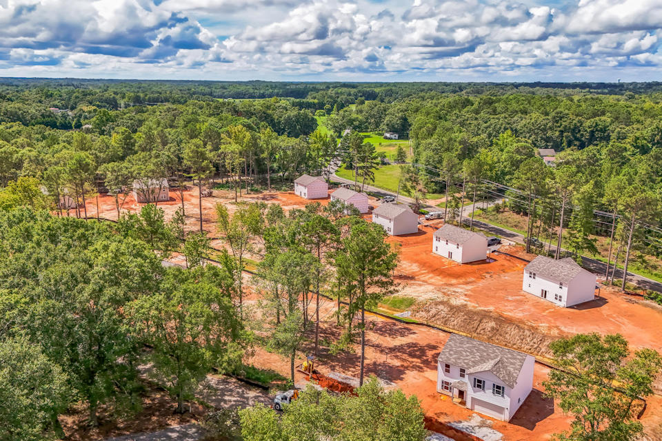 A group of houses surrounded by trees.