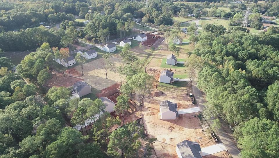 A group of houses surrounded by trees.