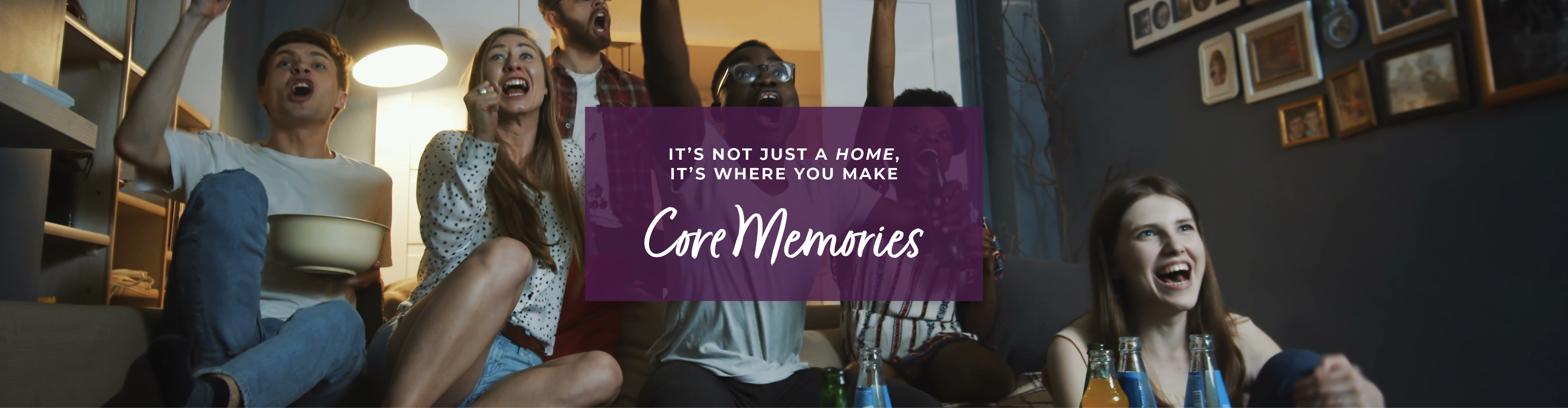 A group of women sitting on a couch and holding a sign.