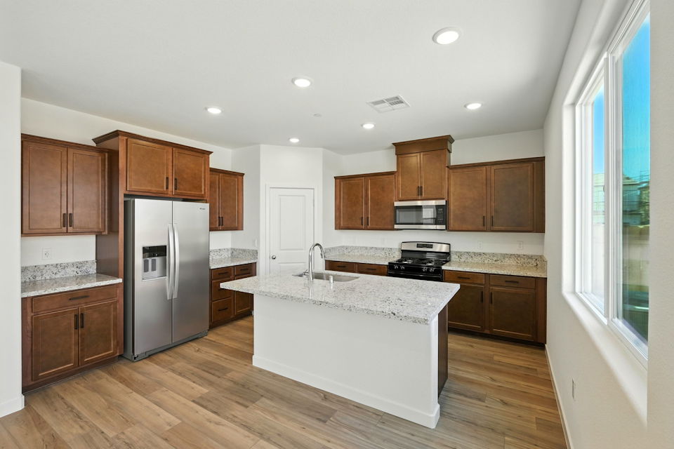 A kitchen with wooden cabinets.