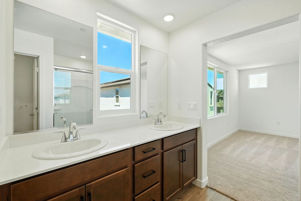 A bathroom with a large mirror.