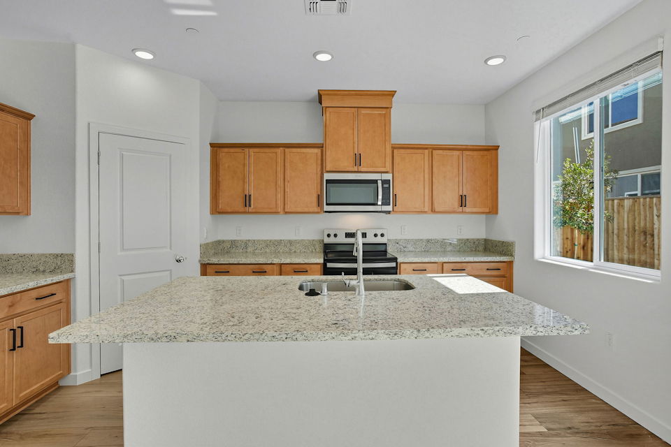 A kitchen with a marble counter top.