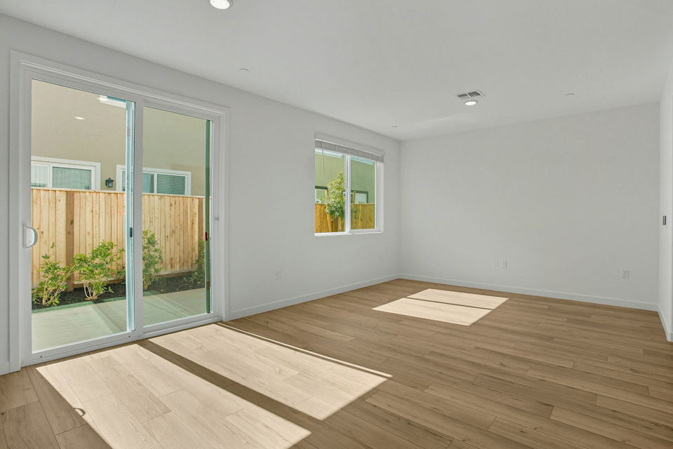 A room with a wood floor and a wood floor with a window.