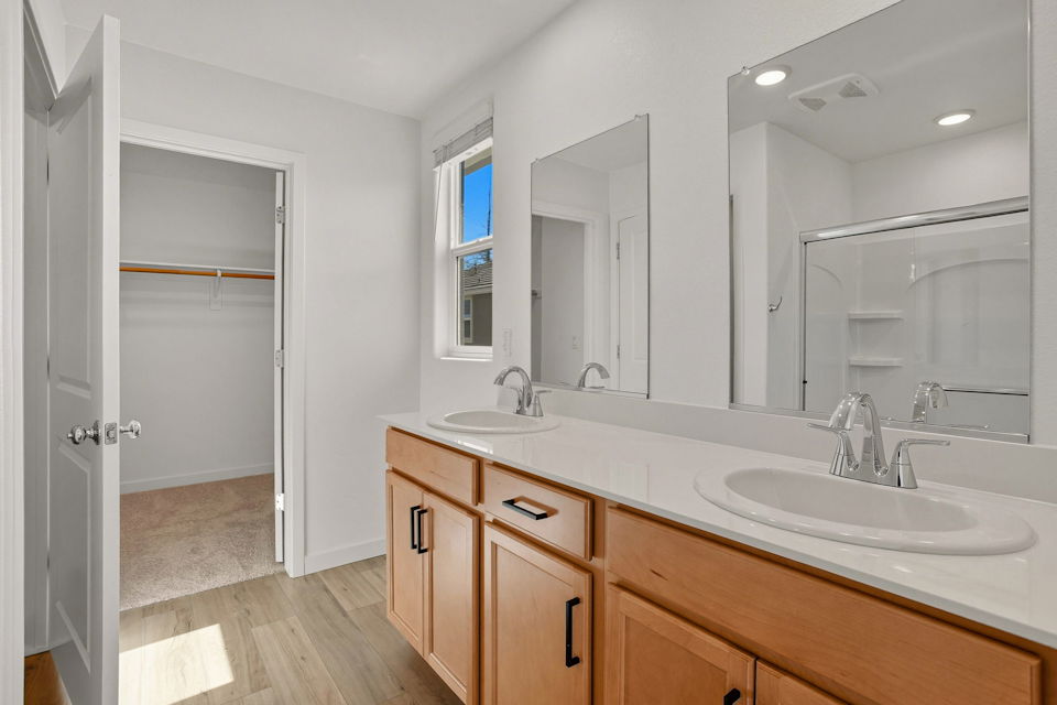 A bathroom with a large mirror.
