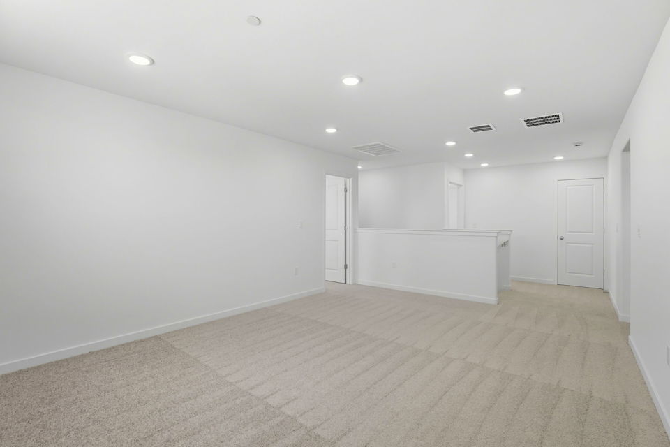 A long hallway with white doors.