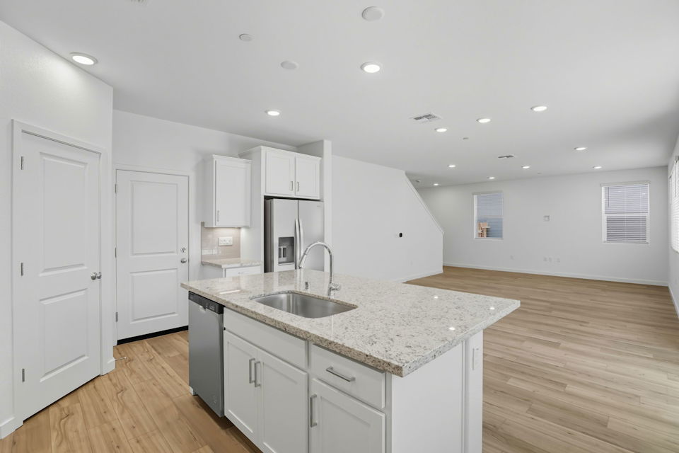 A kitchen with white cabinets.