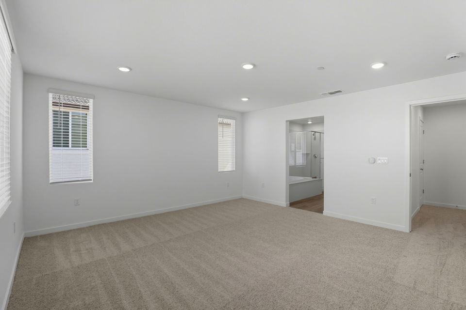 A room with a carpet and a door.