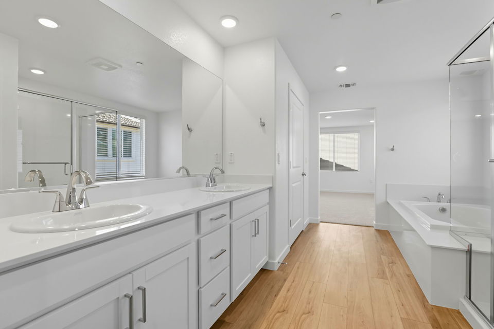 A bathroom with a large mirror.