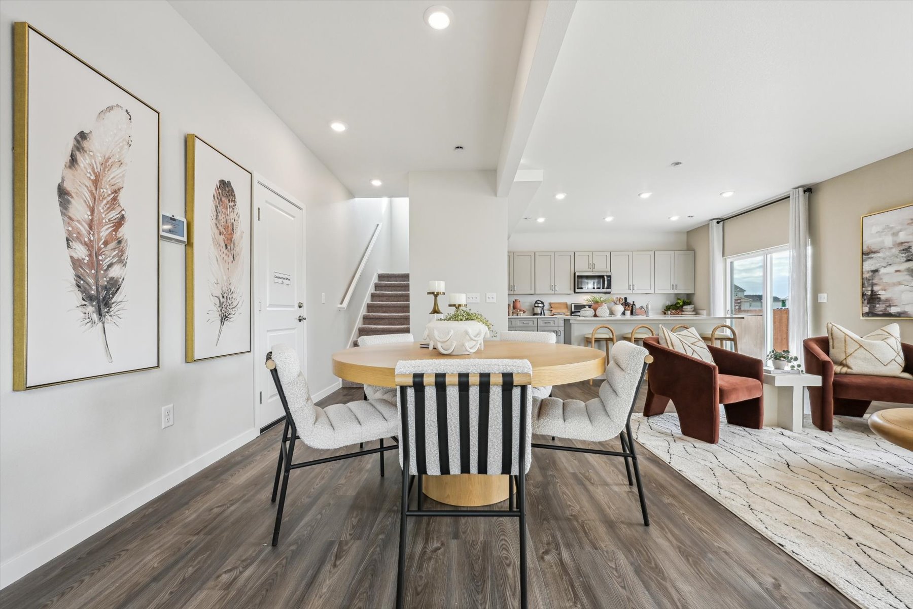 A dining room with a table and chairs.