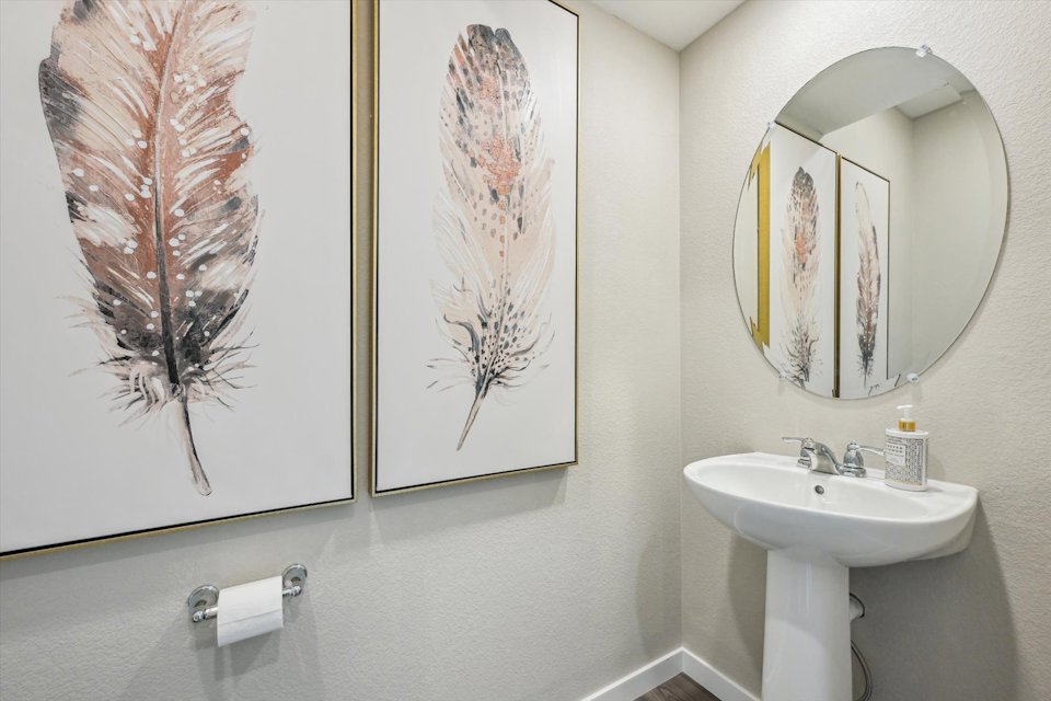 A bathroom with a mirror and a sink.